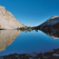 Mountain lake reflecting a deep blue sky