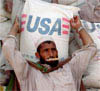 Humanitarian Aid and Economic Development Assistance help reduce conditions that terrorists exploit.  Here, an Afghani collects a bag of wheat distributed by the U.S. Agency for International Development. [AP/WWP] 