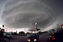 Mobile mesonet vehicles gas up en route to intercepting the supercell thunderstorm ahead of them. 