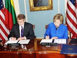 Date: 03/09/2009 Description: Secretary of State Hillary Rodham Clinton and Lithuanian Foreign Minister Vygaudas Usackas sign documents at the State Department. State Dept Photo
