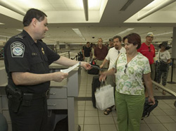 Passenger screening by CBP Officer.