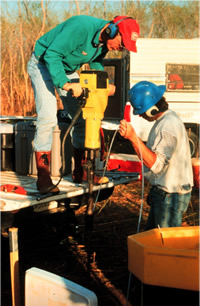 USGS scientists installing a drive point well for contaminant transport studies at the Norman Landfill Research Site, Norman, OK