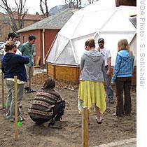 Lamb and his students gather outside the greenhouse to discuss landscaping plans