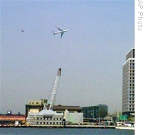 The primary presidential aircraft, a Boeing 747 known as Air Force One when the president is aboard, flies low over New York Harbor, followed by an F-16 chase plane, 27 Apr 2009