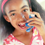 Girl with asthma using an inhaler