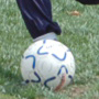 Photo of a Sports Visitor from Pakistan kicking a soccer ball.