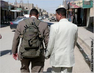 Two men walking down Iraqi street (Aaron Snipe/State Dept.)