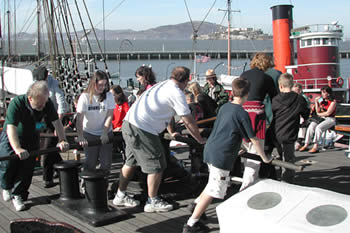 Turning the capstan on Balcluth's foredeck.
