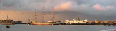 Alcatraz, Hyde Street Pier and Balclutha at sunset on a stormy evening.