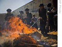 Ultra-Orthodox Jewish men burn leavened items in a final preparation before the Passover holiday, in Jerusalem, Wednesday, 8 April 2009