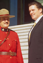 A special agent ,right, consults with a Canadian Royal Mounted Police officer ,left,.