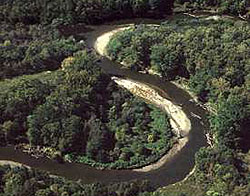 Accumulating sediments form sand bars along the banks of the Cuyahoga River as it winds its way through this forested section of the Cuyahoga Valley.