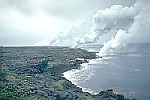 White acid-rich steam plume rises from lava flows entering the sea
