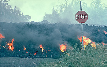 `A`a lava flow moves through intersection, Royal Gardens subdivision, Kilauea Volcano, Hawai`i