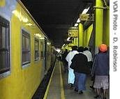 Minutes after arrival, the last passengers off a commuter train from Soweto rush from the platform to work in downtown Johannesburg 