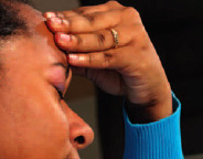 Photo of a woman holding her head