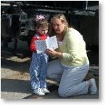 A young visitor and her mother  are 'Exploring Steamtown'.