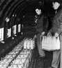Fresh milk is loaded on a C-47. Shipments of whole milk soon were dropped in favor of lighter weight condensed milk. 