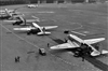 C-47 transport aircraft, each containing 190 sacks of flour, arrive at Tempelhof Airport,  July 2, 1948. A pair of B-17 weather aircraft can be seen at the far side of the airfield along with a lone C-54 at the extreme right. 