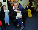 Department of Commerce's Carlos Gutierrez gets a huge hug from one little trick or treater at the Department of Commerce.