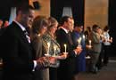 Photo shows first few rows of people holding lit candles and participating in the Candlelight Ceremony held, for NCVRW 2009, indoors at the U.S. Chambers of Commerce.