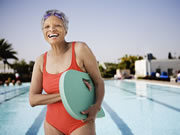 Photo of a senior woman standing by the pool