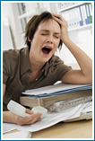 Woman Yawning At Desk