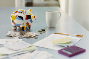 Picture of money, a calculator, and a piggy bank