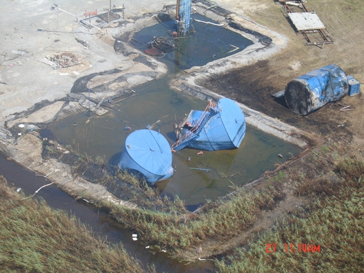 Aerial view of flooded and muddy silos.