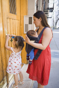 a woman caring for an infant and a young child