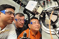 Scientists Yu-Sheng Chen, Mercouri Kanatzidis and Santanu Banerjee examine the X-ray diffraction machine at the ChemMatCARS beamline in the Advanced Photon Source