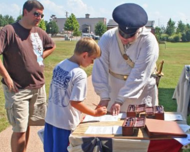 A young visitor signs up to join the garrison