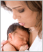 Photo of a woman holding an infant.