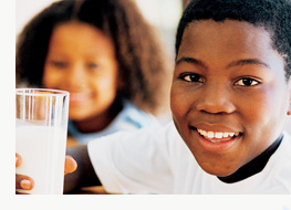 a boy holding a glass of milk