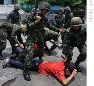 Thai soldiers detain an anti-government protester following clashes in Bangkok, Thailand, 13 Apr 2009.