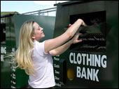 Photo: A woman depositing items in a clothing bank