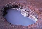 Photo of cloudy blue water in one of the hot springs along the Artist Paint Pots Trail.