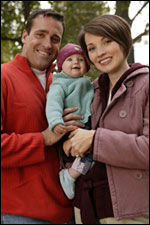 Photo: Parents holding a  baby