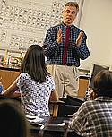 Students listening to Teacher in a classroom.