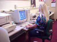 [Worker entering data on a computer keyboard]