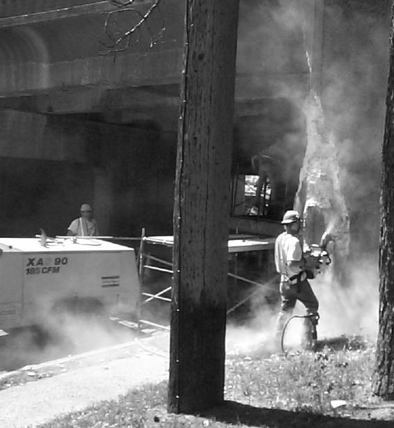 Worker in a large cloud of dust