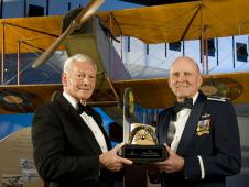 Gen. John R. 'Jack' Dailey, Director of the Smithsonian’s National Air and Space Museum, presents the Trophy for Lifetime Achievement, the museum’s highest honor, to former NASA astronaut and research pilot C. Gordon Fullerton.