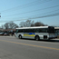 Silver bus pulls away from street in front of Patchogue Railroad Station.