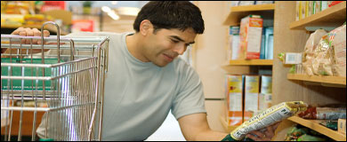 Photo: A man reading the label of a food package