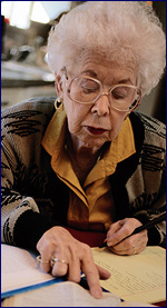 An elderly woman doing research