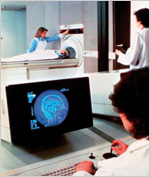 patient undergoing scan with clinician watching a computer monitor