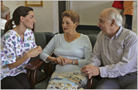 nurse talking to older couple
