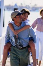 Photograph of a father giving his son a piggyback ride