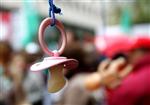 A baby pacifier hangs from an umbrella in Brussels December 2, 2005. REUTERS/Francois Lenoir