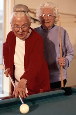 Picture of the 2 older women playing pool.